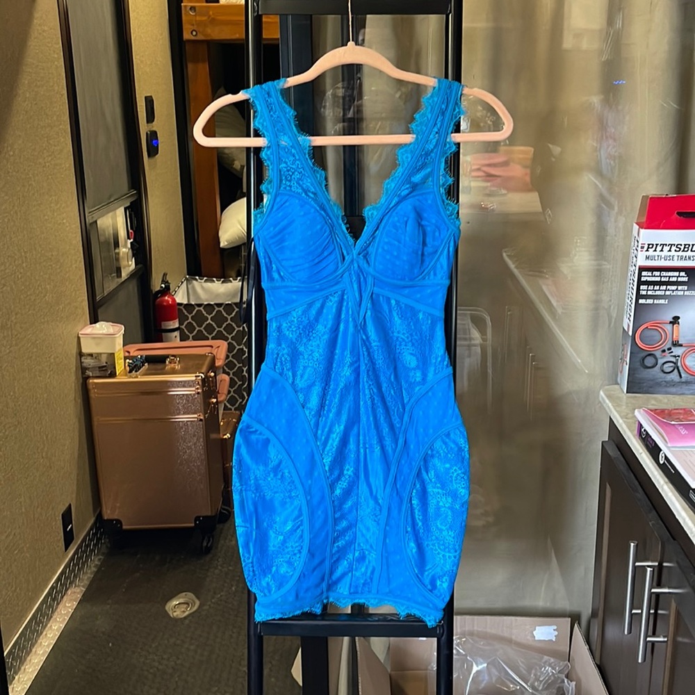 Bebe blue mini dress, small makeup stain on left side breast area.